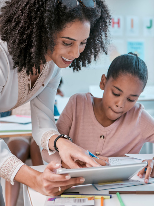 Teacher helping young girl